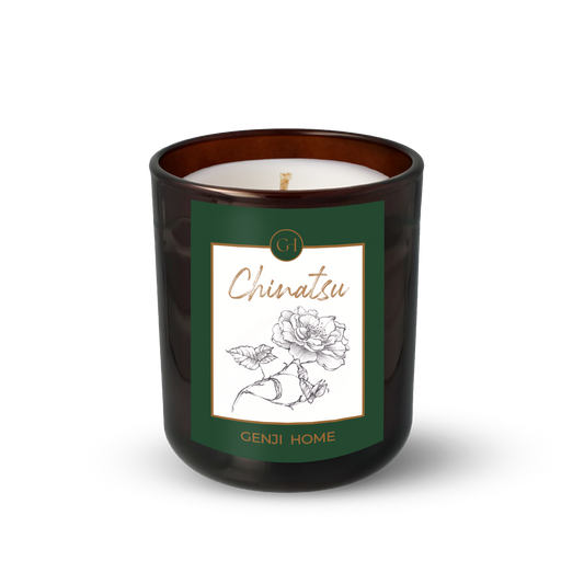 Chinatsu Olive Wax Candle by Genji Home  in a amber glass container with a green label featuring 'Genji Home' branding.