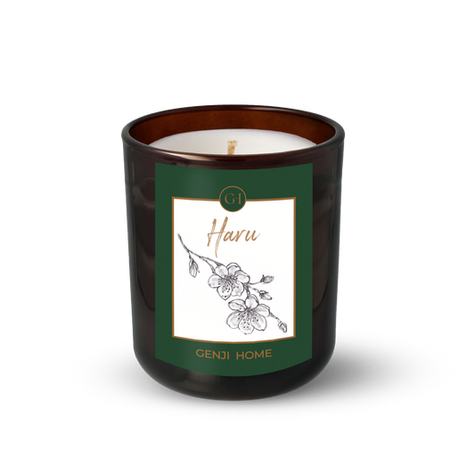 Haru Olive Wax Candle by Genji Home  in a amber glass container with a green label featuring 'Genji Home' branding.