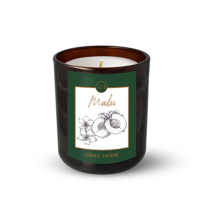 Malu Olive Wax Candle by Genji Home  in a amber glass container with a green label featuring 'Genji Home' branding.