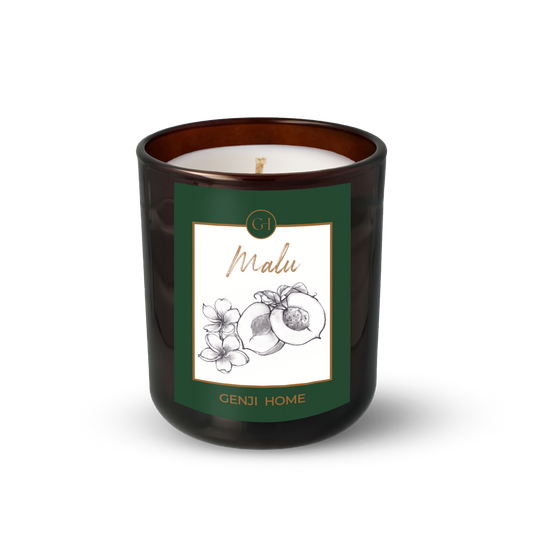 Malu Olive Wax Candle by Genji Home  in a amber glass container with a green label featuring 'Genji Home' branding.