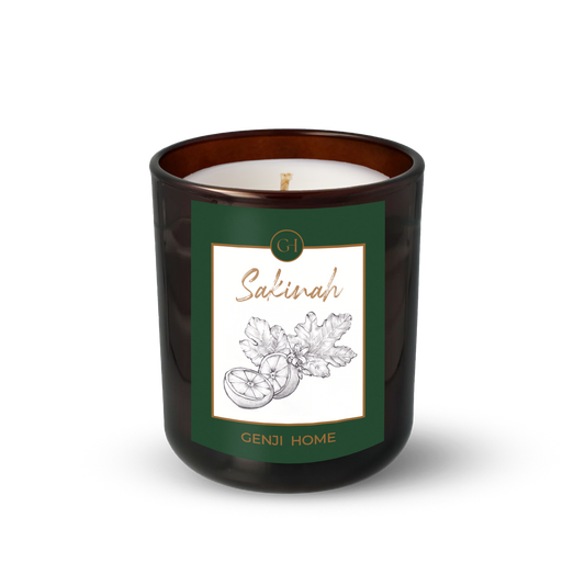 Sakinah Olive Wax Candle by Genji Home  in a amber glass container with a green label featuring 'Genji Home' branding.