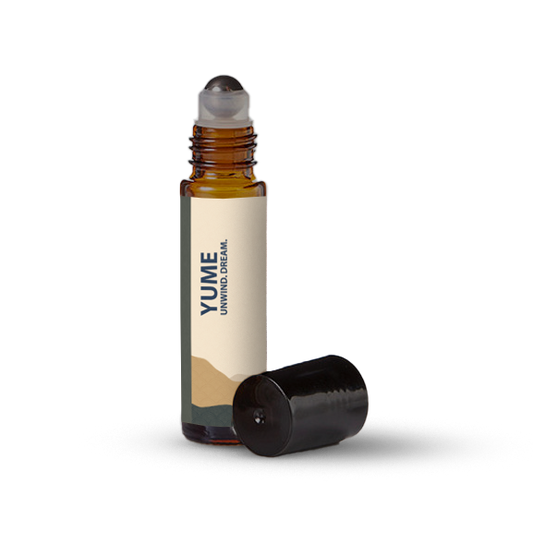 Yume essential oil roller bottle on a transparent background.